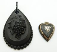Victorian carved jet pendant depicting a grape vine and an inlaid heart pendant