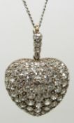 An early 20thC heart pendant / locket set with round cut diamonds, the centre diamond measuring