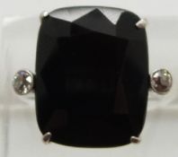 A platinum ring set with a cushion cut quartz and two old cut diamonds, 3.7g, size M