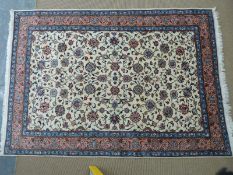Floral rug with cream ground central panel and pink and blue border, 300 x 210cm
