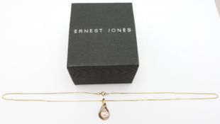 A 9ct gold pendant set with a pearl and diamond