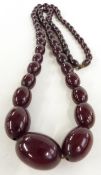 A graduated cherry amber necklace made up of 63 oval beads, 73g