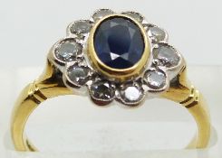 An 18ct gold ring set with an oval cut sapphire surrounded by diamonds, 4.3g, size N