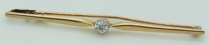 A 9ct gold bar brooch set with an old cut diamond measuring approximately 0.2ct
