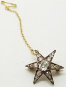 An early Victorian brooch set with a central cushion cut diamond measuring approximately 0.7ct and