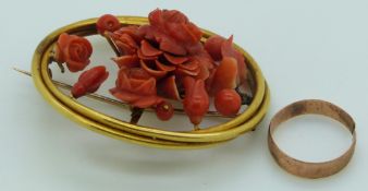 A yellow metal 19thC brooch set with carved coral and a 9ct gold ring