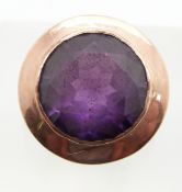 A 9ct rose gold ring set with a synthetic purple sapphire, 6.8g, size N