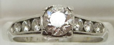 A platinum ring set with a diamond measuring approximately 0.65ct and six further diamonds to the