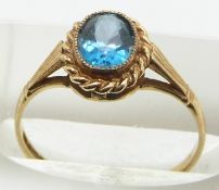 A 9ct gold ring set with an oval cut topaz, 1.4g, size L