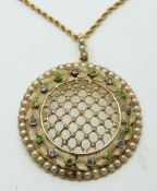 Edwardian circular pendant set with seed pearls in a lattice design within a border set with