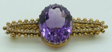 Edwardian 15ct gold brooch set with a large oval cut amethyst and seed pearls, 4.7g