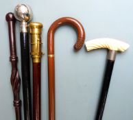 Five walking sticks with various ornamental handles