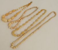 Three ivory necklaces and a bone necklace