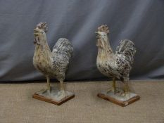 A pair of Chinese pottery cockerels on wooden plinths, height 51cm