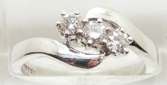 COLLECTING An 18ct white gold ring set with three diamonds in a twist setting, 5.4g , size N