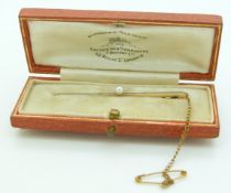 A 15ct gold and platinum brooch set with a pearl in a Goldsmiths and Silversmiths Company box