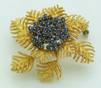 An 18ct gold brooch in the form of fern leaves set with sapphires in a cluster, 4cm, 13.1g