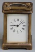 Carriage clock in brass corniche style case, enamel Roman dial with blued steel hands, 11cm tall