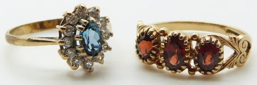 A 9ct gold ring set with three garnets and a 9ct gold ring set with a topaz, 4.3g, size M