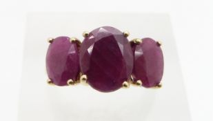 A 9ct gold ring set with three oval rubies, 3.4, size L