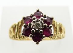 An 18ct gold ring set with rubies and a diamond in a cluster, 4.8g, size P/O