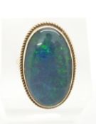 A 9ct gold ring set with an opal triplet within a rope twist border, 6.2g, size L