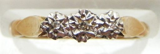 An 18ct gold ring set with three diamonds, 3.1g, size M