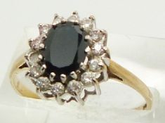 A 9ct gold ring set with a sapphire surrounded by cubic zirconia, 2.1g, size S