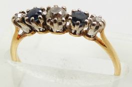 An 18ct gold ring set with three diamonds and two sapphires in a platinum mount, 1.9g, size K