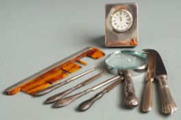 Quantity of hallmarked silver mounted items to include small clock, magnifying glass, comb, knives