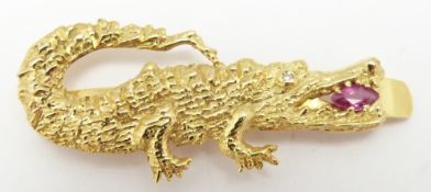 An 18ct gold crocodile clip set with a marquise cut ruby and a diamond eye, 5.8g