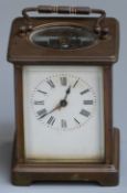 Carriage clock in brass case, the enamel Roman dial with steel hands, the keyless movement visible