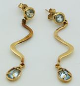 A pair of 9ct gold earrings set with a round and pear cut aquamarines, 4.3g