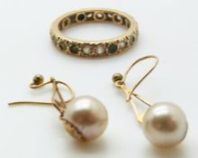 A 9ct gold eternity ring (2.6g) and a pair of 9ct gold earrings set with a faux pearl to each