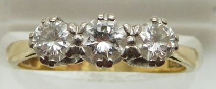 An 18ct gold ring set with three diamonds measuring approximately 0.32ct, 0.25ct & 0.25ct, 3.6g,