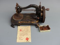 Vintage Wellington sewing machine with certificate of quality and canvas pin purse.