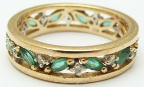 A 9ct gold eternity ring set with marquise cut emeralds and diamonds, in original Brooks & Bentley