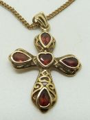 A 9ct gold cross pendant set with garnets, 3 x 2cm, 4.3g