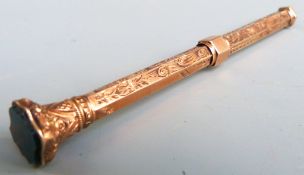 Yellow metal propelling pencil with hardstone finial, marked E.B 9ct, length when extended 13.5cm,