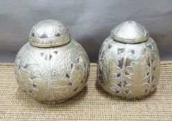 Two white metal overlaid lidded coconut jars with embossed detail, tallest 13.5cm