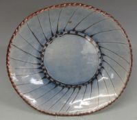 A collection of Studio pottery including large dish with tadpole pattern together with French