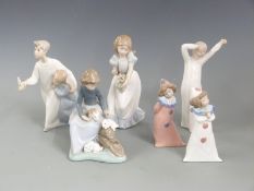 Six Nao child figures including two clowns, girl with rabbits etc, tallest 22cm