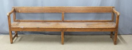 A 19thC pine pew raised on six legs united front to back by simple wooden strainers, ex Cinderford