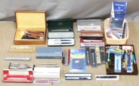 A collection of modern pens and writing equipment including Parker