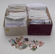 Two boxes of loose stamps in envelopes