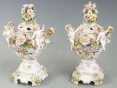 A pair of continental figural potpourri with applied flower decoration, with anchor marks to base,