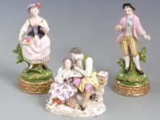 A pair of continental figures of sweethearts with crossed swords to base and a similar group with