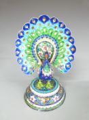 A white metal model of a peacock with enamel decoration, 25cm tall