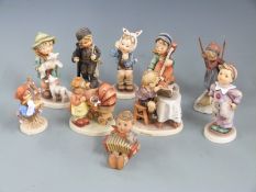 A collection of Goebel Hummel figures including Skier, Cello Player etc