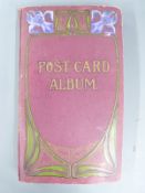 An Edwardian postcard album of topographical, humorous and silk postcards including Chichester,